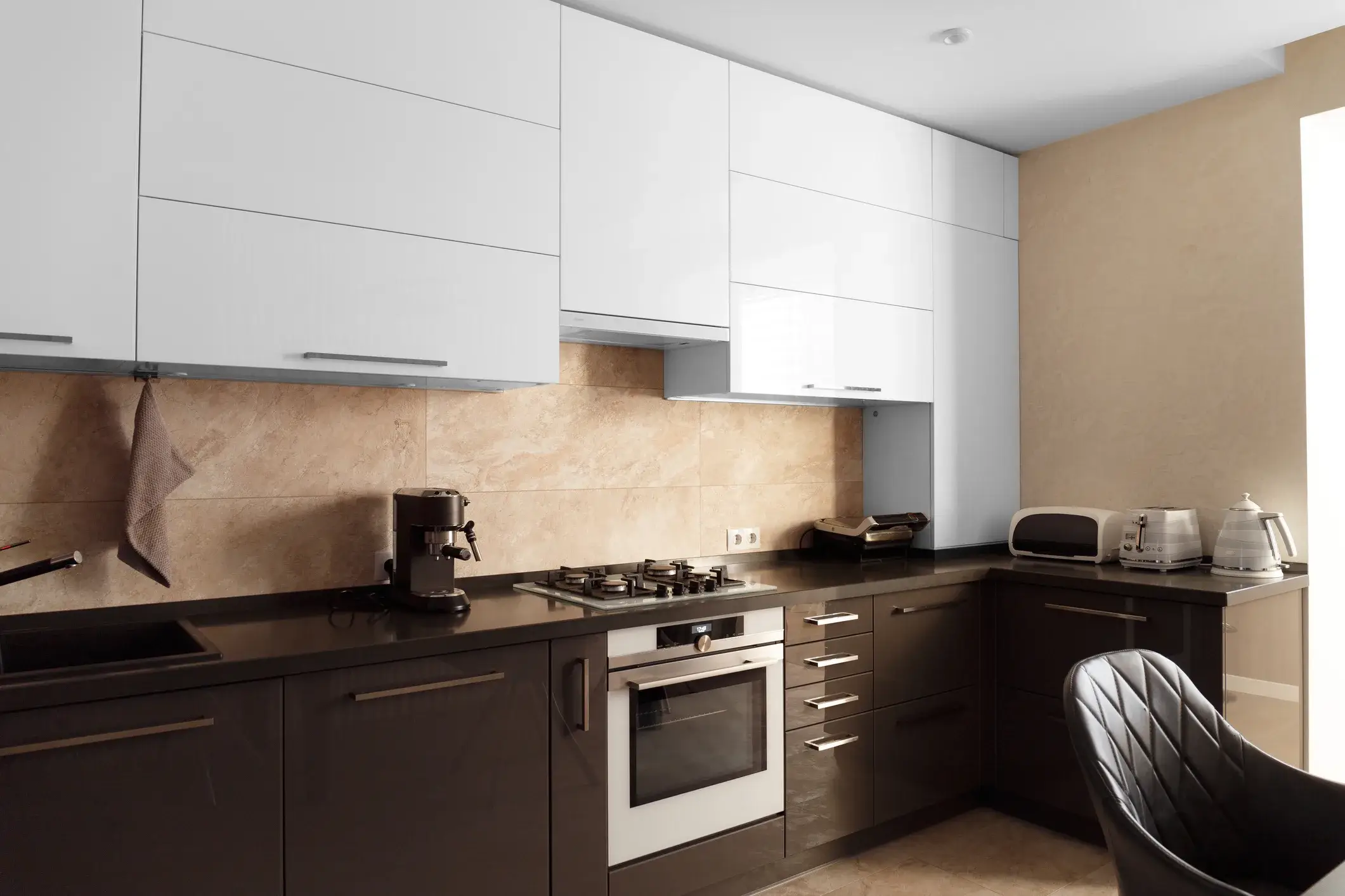 Kitchen cabinets painted white on top and black on the bottom