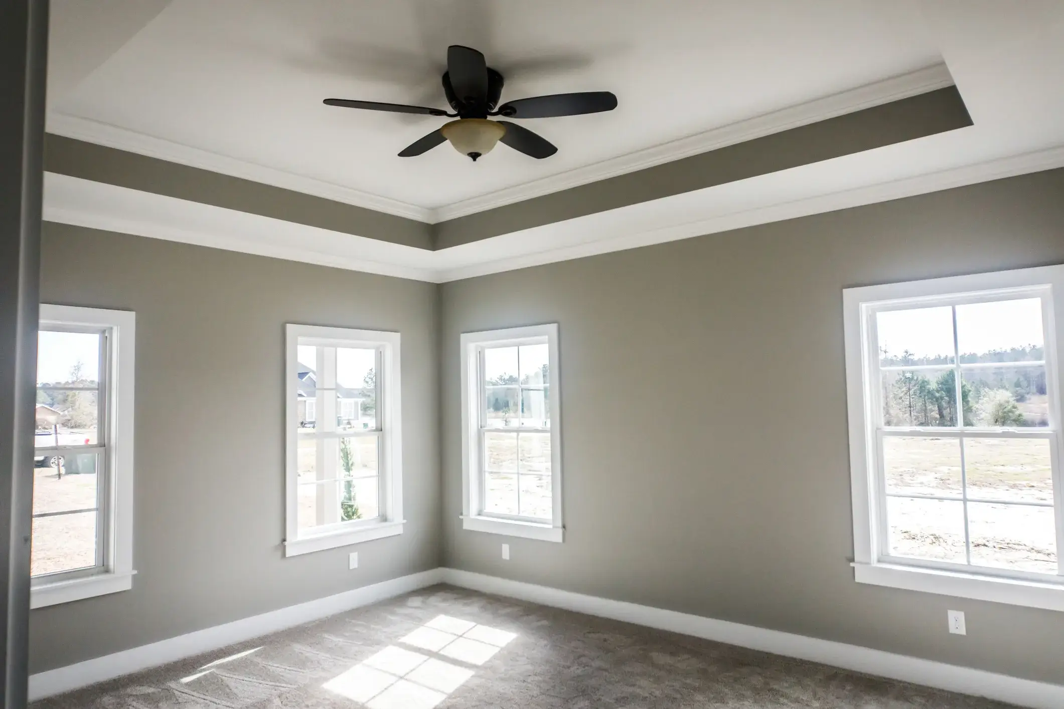 Bedroom with greige walls and white trim