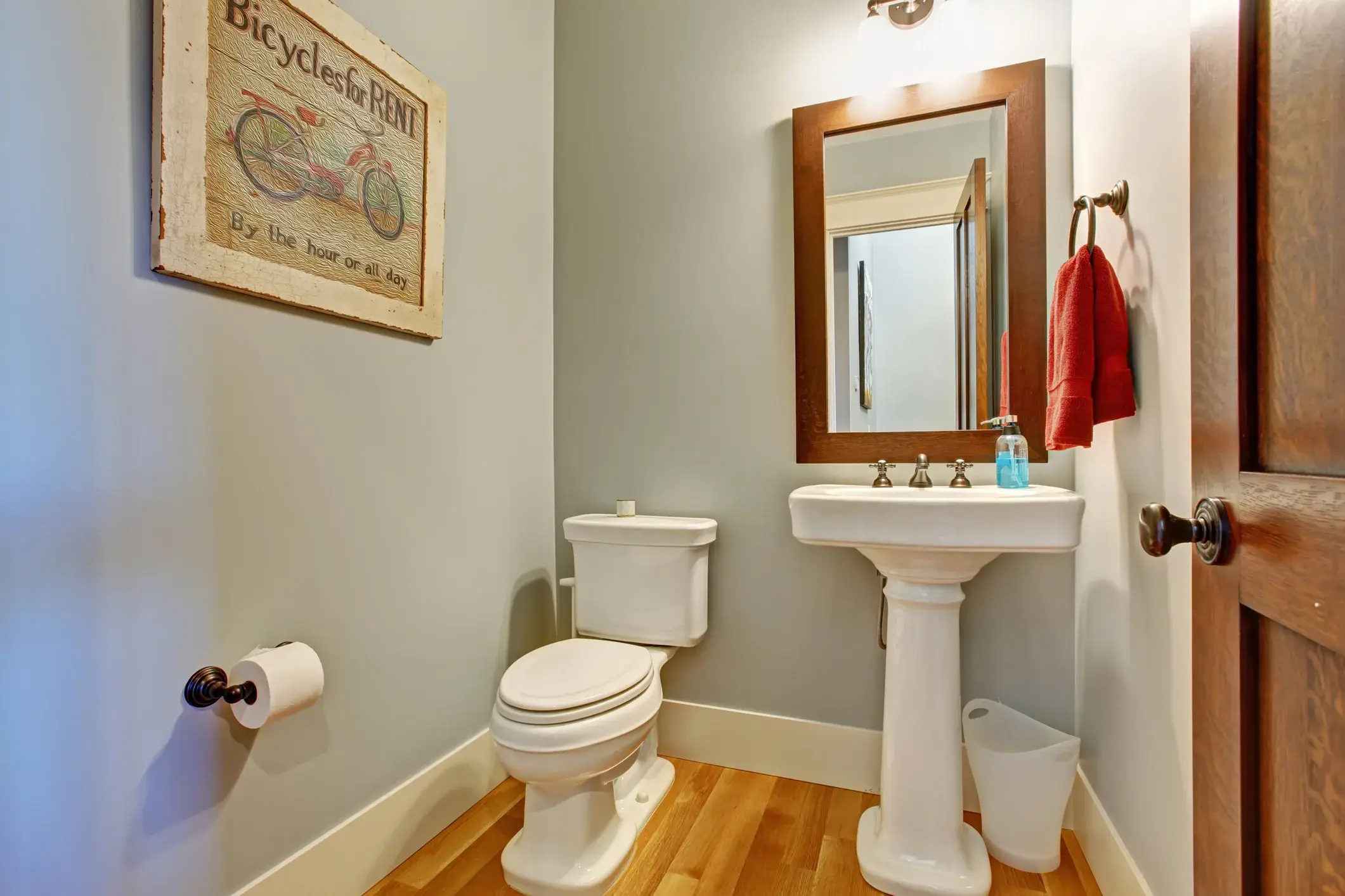 A bathroom interior in light tones with a hardwood floor