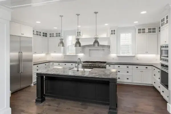 Atlanta luxury kitchen with dark island, pendant lights, and white cabinets - Professional Cabinet Painting