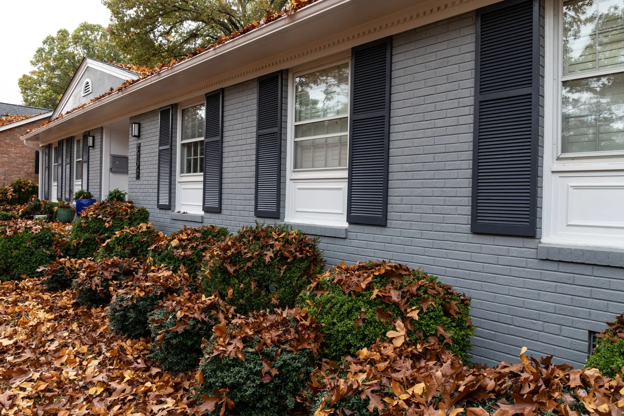 Brick home exterior painted beige with white trim