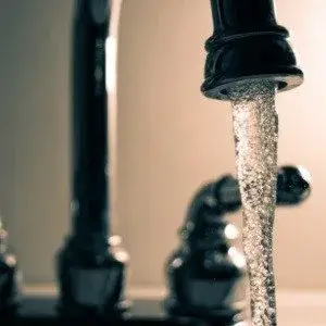 Black Faucet Running in newly painted Buckhead kitchen