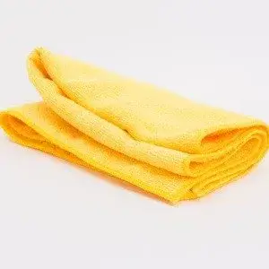 A yellow microfiber dish towel, a great option for cleaning kitchen cabinets