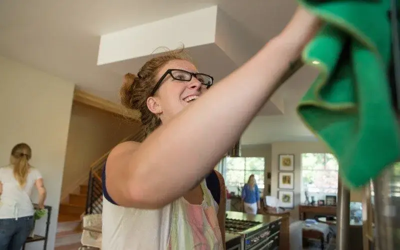 Georgian Woman Cleaning Kitchen Cabinets