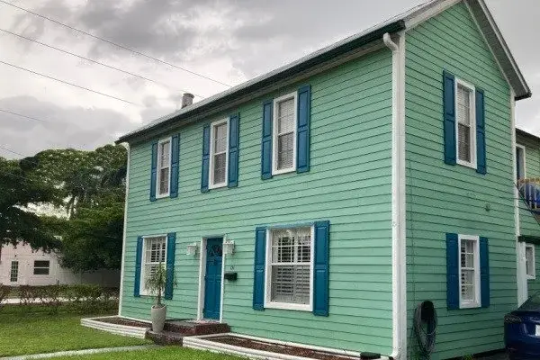 Green Colonial house with fresh exterior paint in Alpharetta, GA