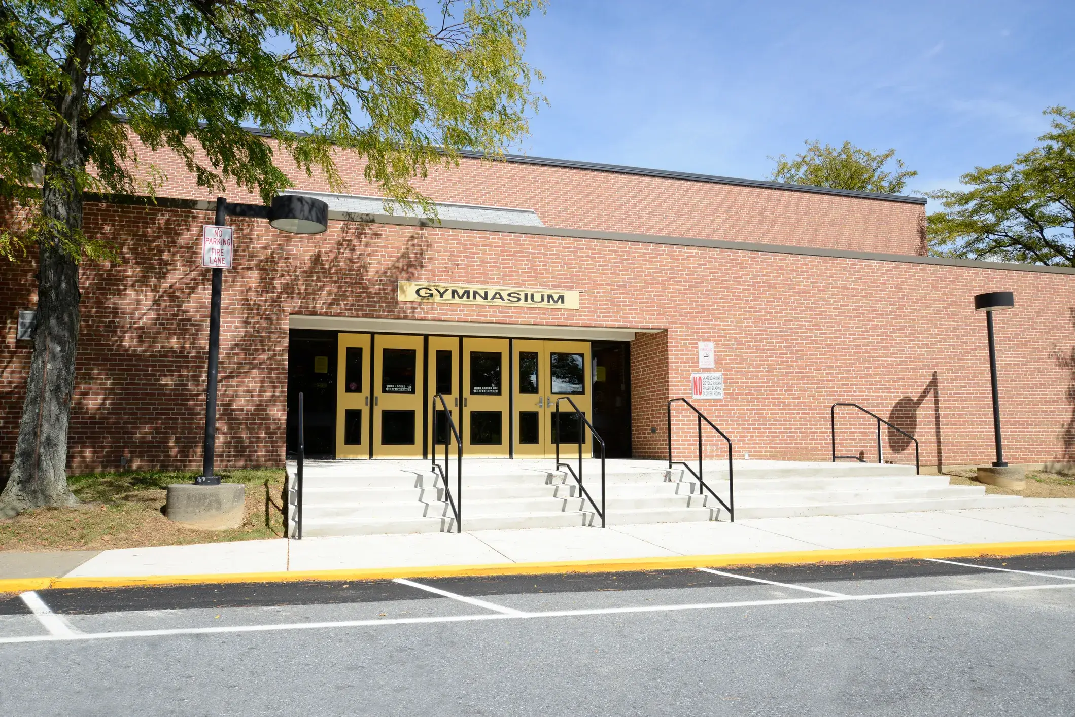 A school gymnasium entrance with a painted brick exterior