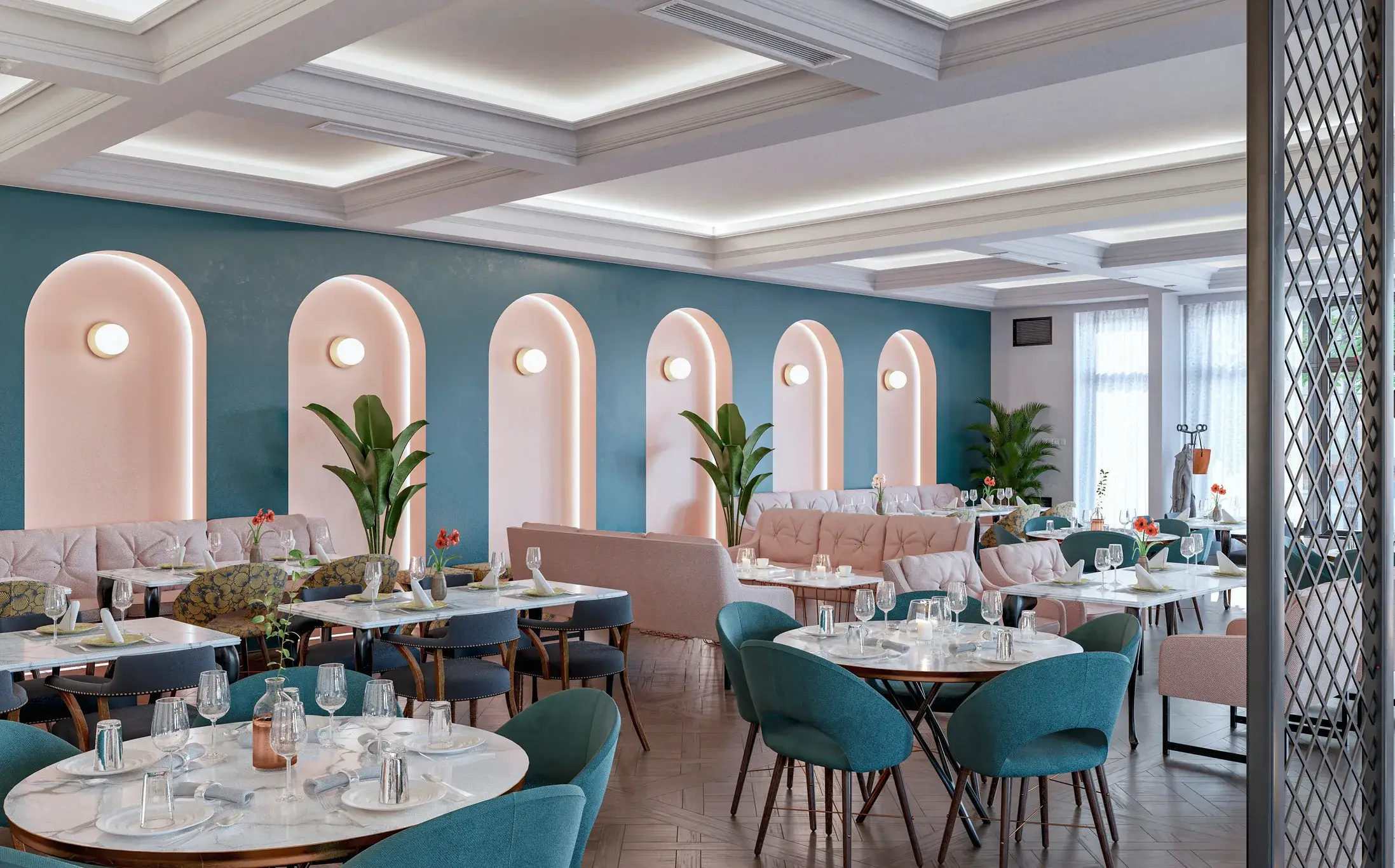 A restaurant dining room with teal painted walls and pink arched alcoves