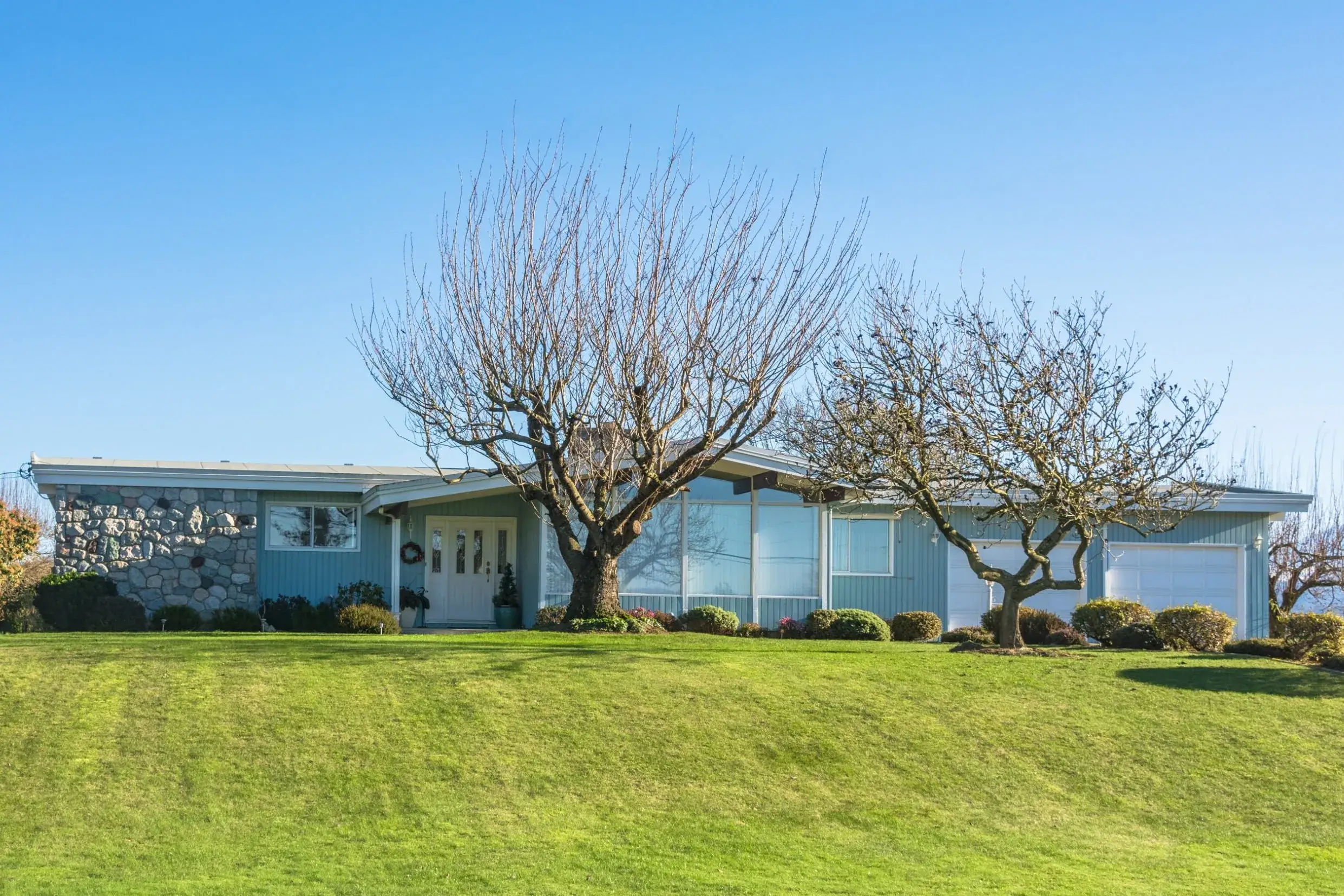 Contemporary exterior painting on a blue mid-century home