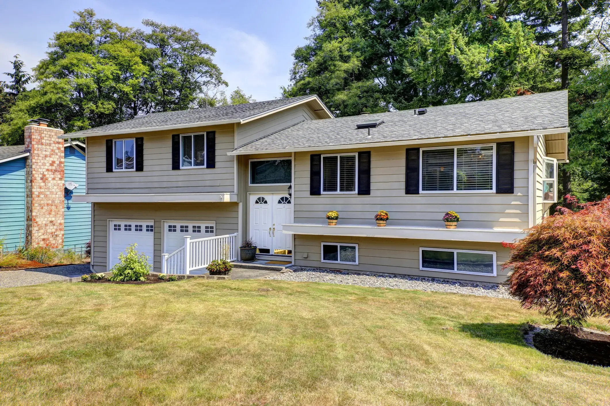 Cape Cod home exterior painted beige with white trim