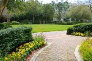 Exterior House Painting Tips - Kimberly Painting - Roswell, GA - Red Paver Driveway with Yellow Flowers Landscaping