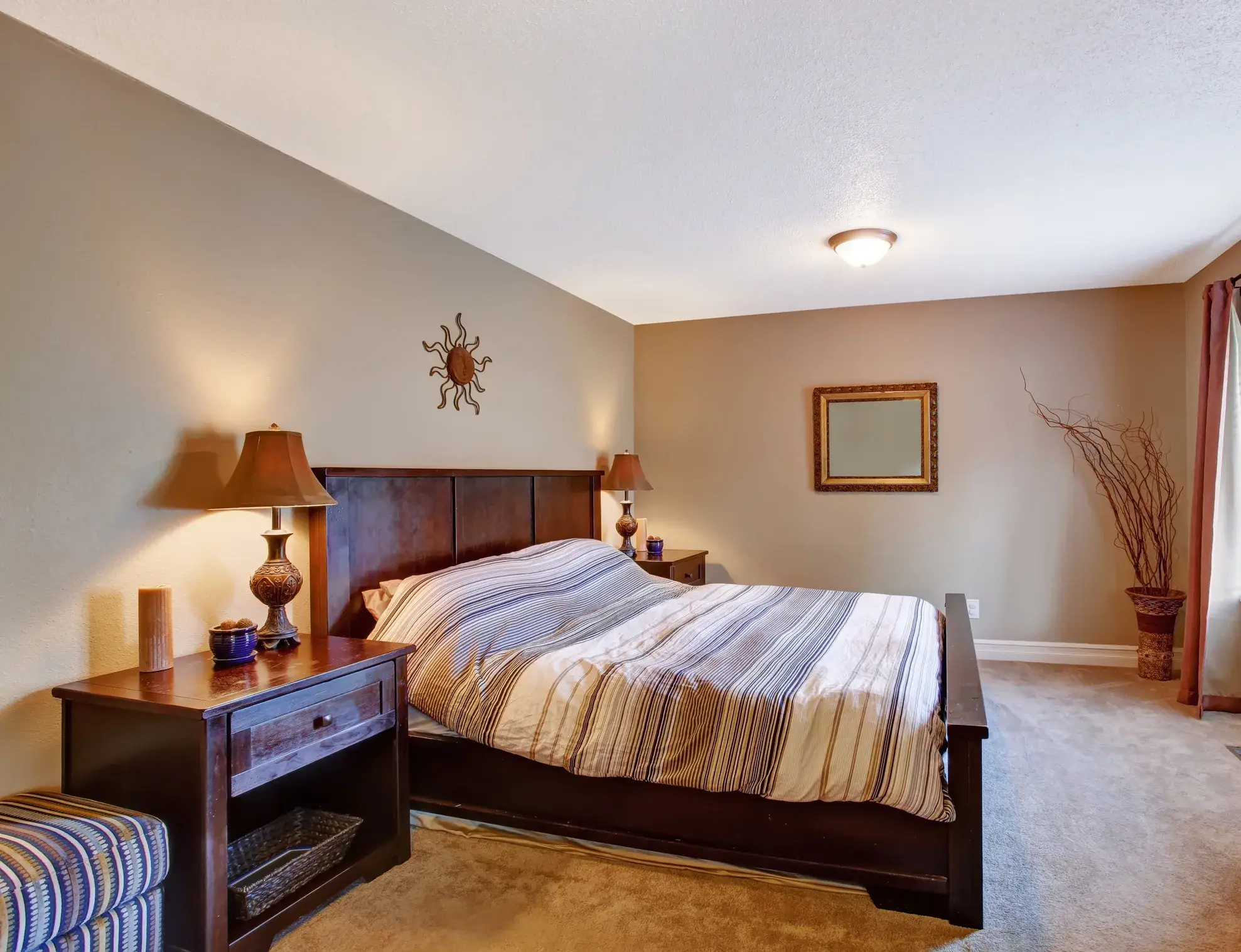 A traditional bedroom with painted walls and striped bedding