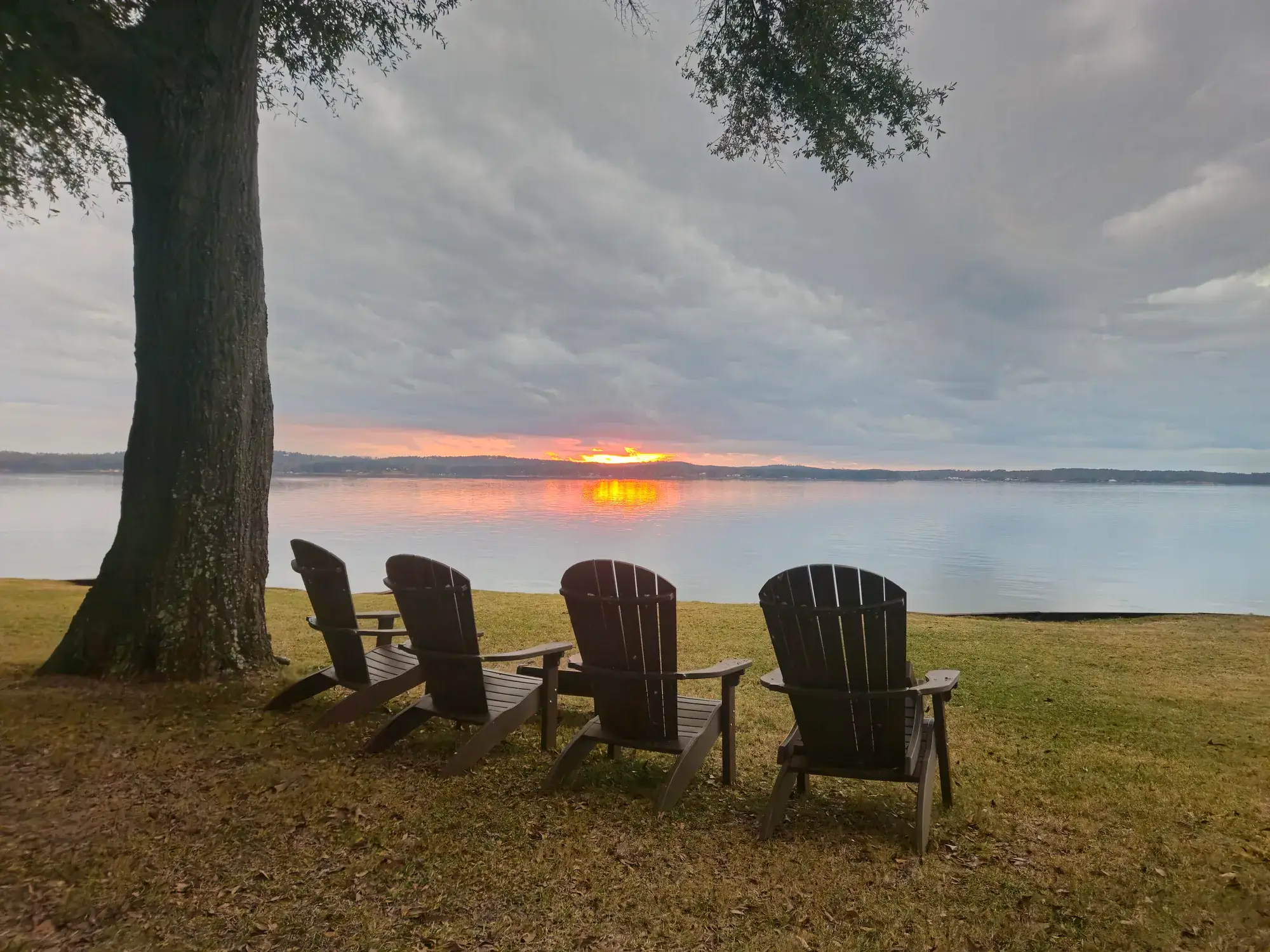 Adirondack chairs facing the water at sunset near Atlanta, Georgia