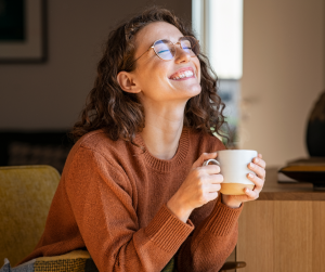 Woman with coffee, happy about her wall paint choice
